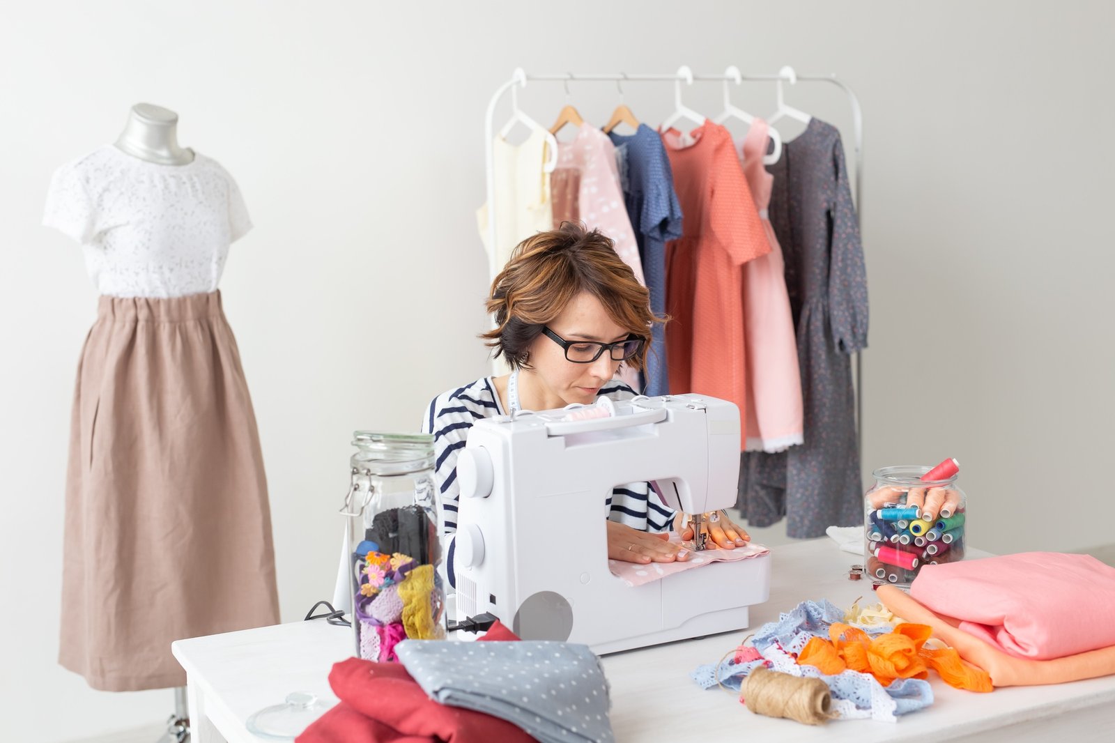 clothing-designer-seamstress-people-concept-clothing-designer-working-in-her-studio